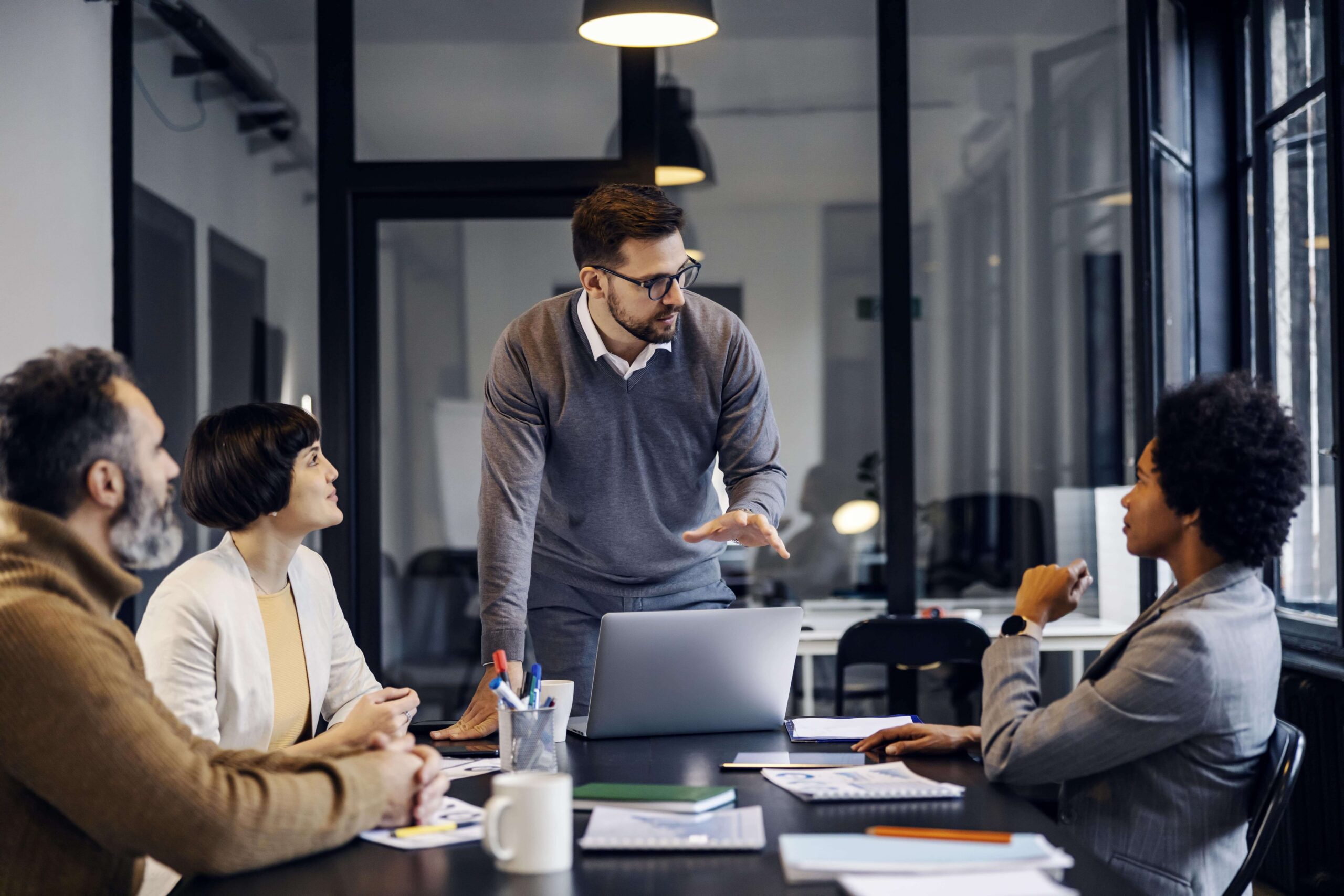 businessman-having-presentation-with-colleagues-about-project-he-working-office-min